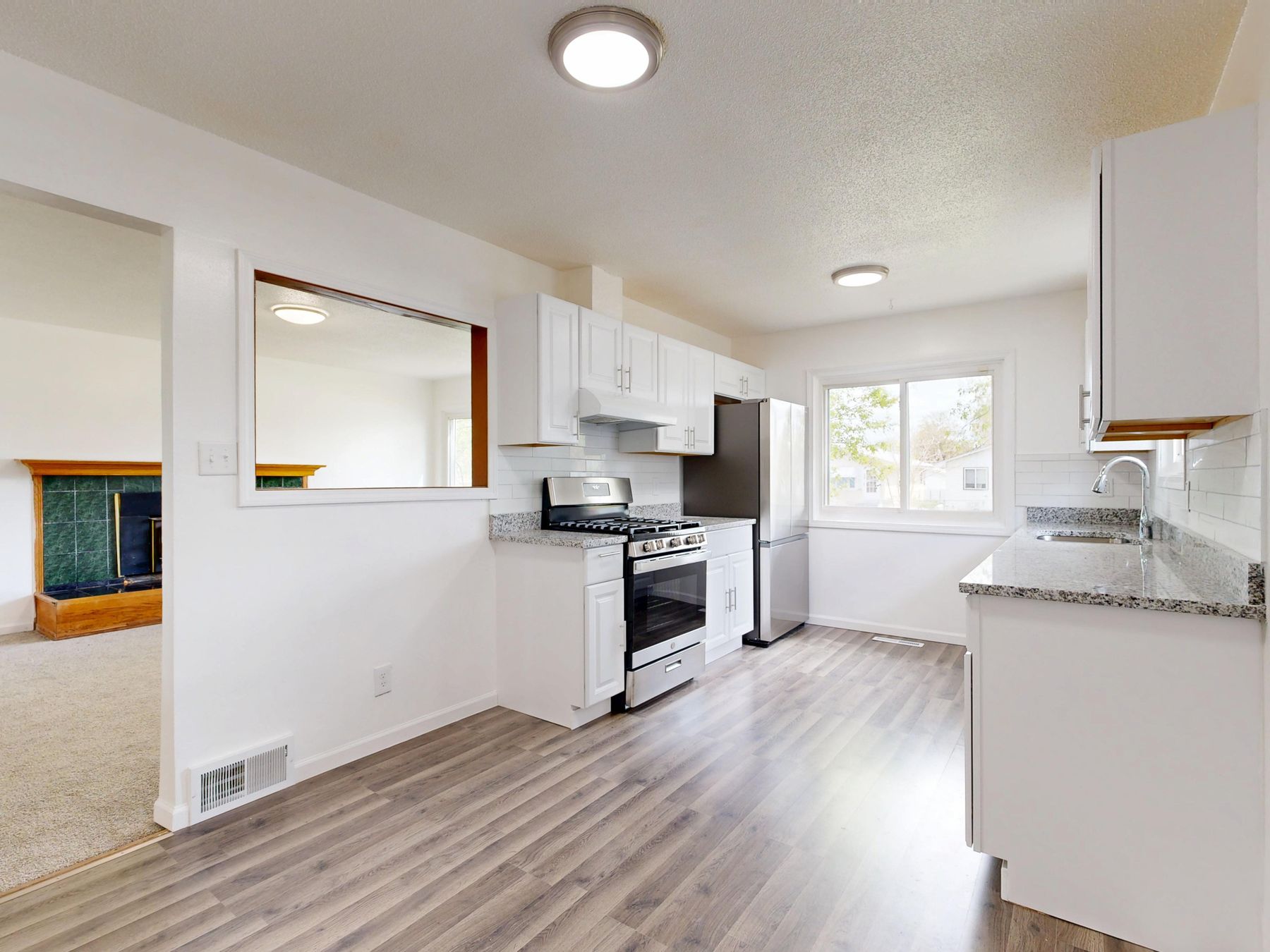 Bright completed kitchen with white cabinetry